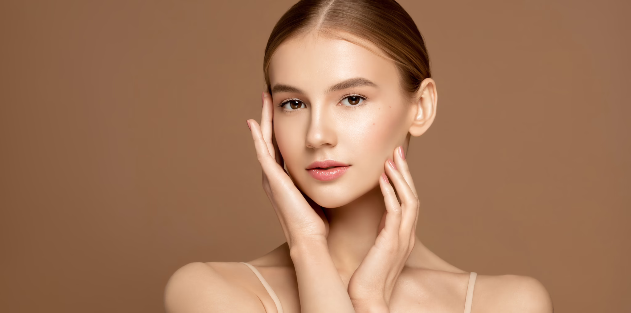 Woman receiving a HydraFacial® treatment in a spa setting — glowing skin and relaxed expression, highlighting hydration and radiance.