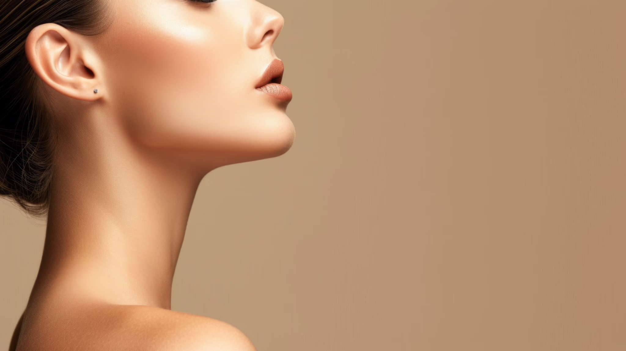 Woman smiling with a defined jawline after non-surgical Kybella chin sculpting treatment